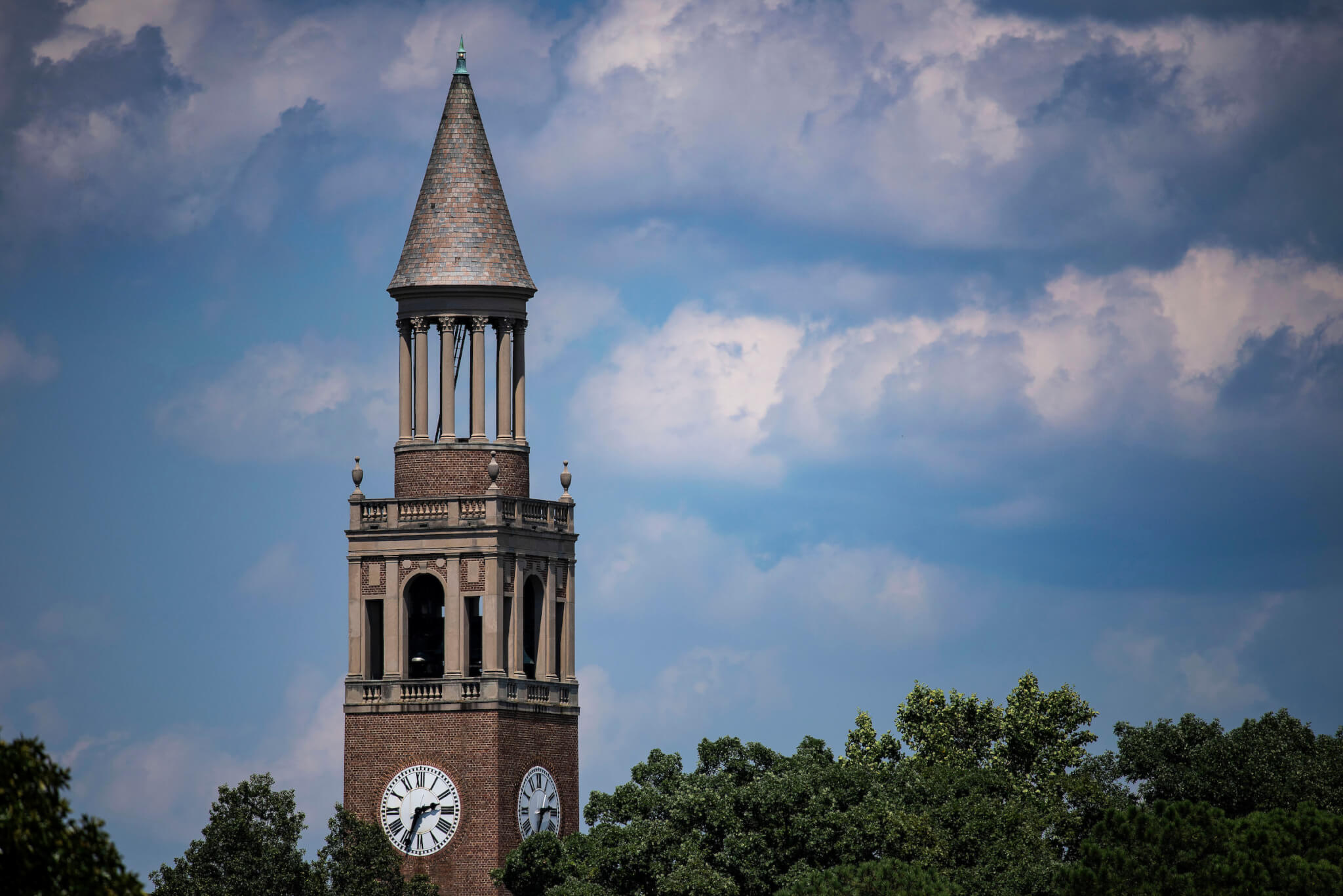 The top Morehead-Patterson Bell Tower set against a partially cloudy sky
