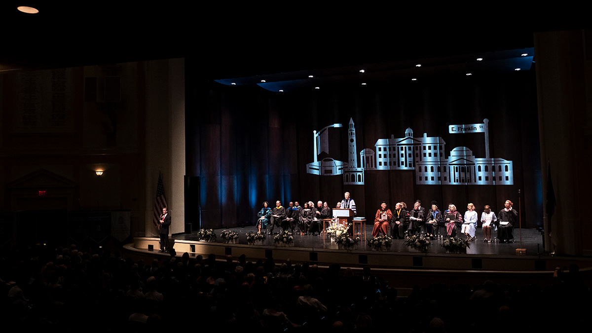 Faculty, staff, and guests on stage at University Day